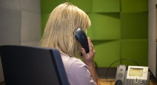 A volunteer on the phone listening to a caller