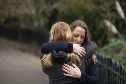 Women-hug-outdoors