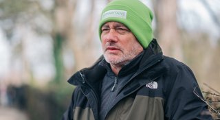A photo of a man stood outside with a Samaritans hat on (Outside_568_AR)